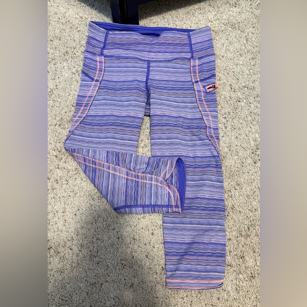 Women’s Pacesetter running capris in Purple and coral stripe pattern